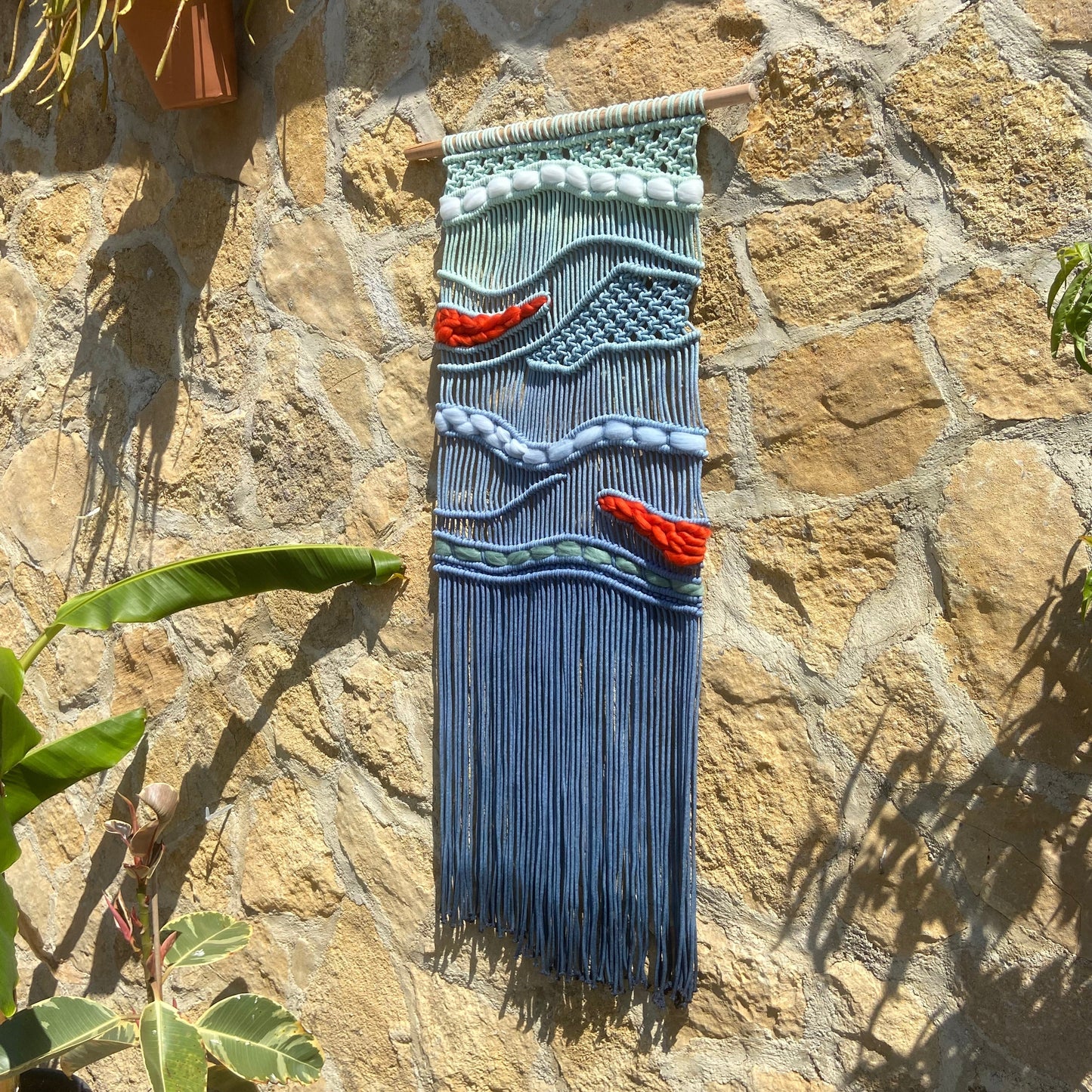 Tapiz 117 - El Murmullo del Mar Rojo - Tapiz de macramé azul con olas y acentos rojos – decoración de pared artesanal inspirada en el mar